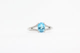 White Gold Blue Topaz Split Shank Ring